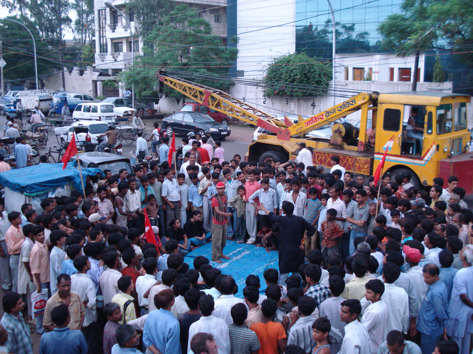 A group of people standing in front of a large crowd of people

Description automatically generated